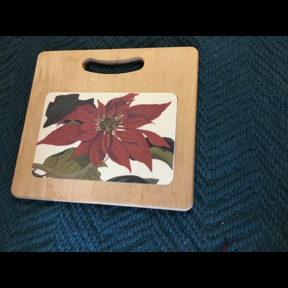 Wood cutting board with ceramic poinsettia insert